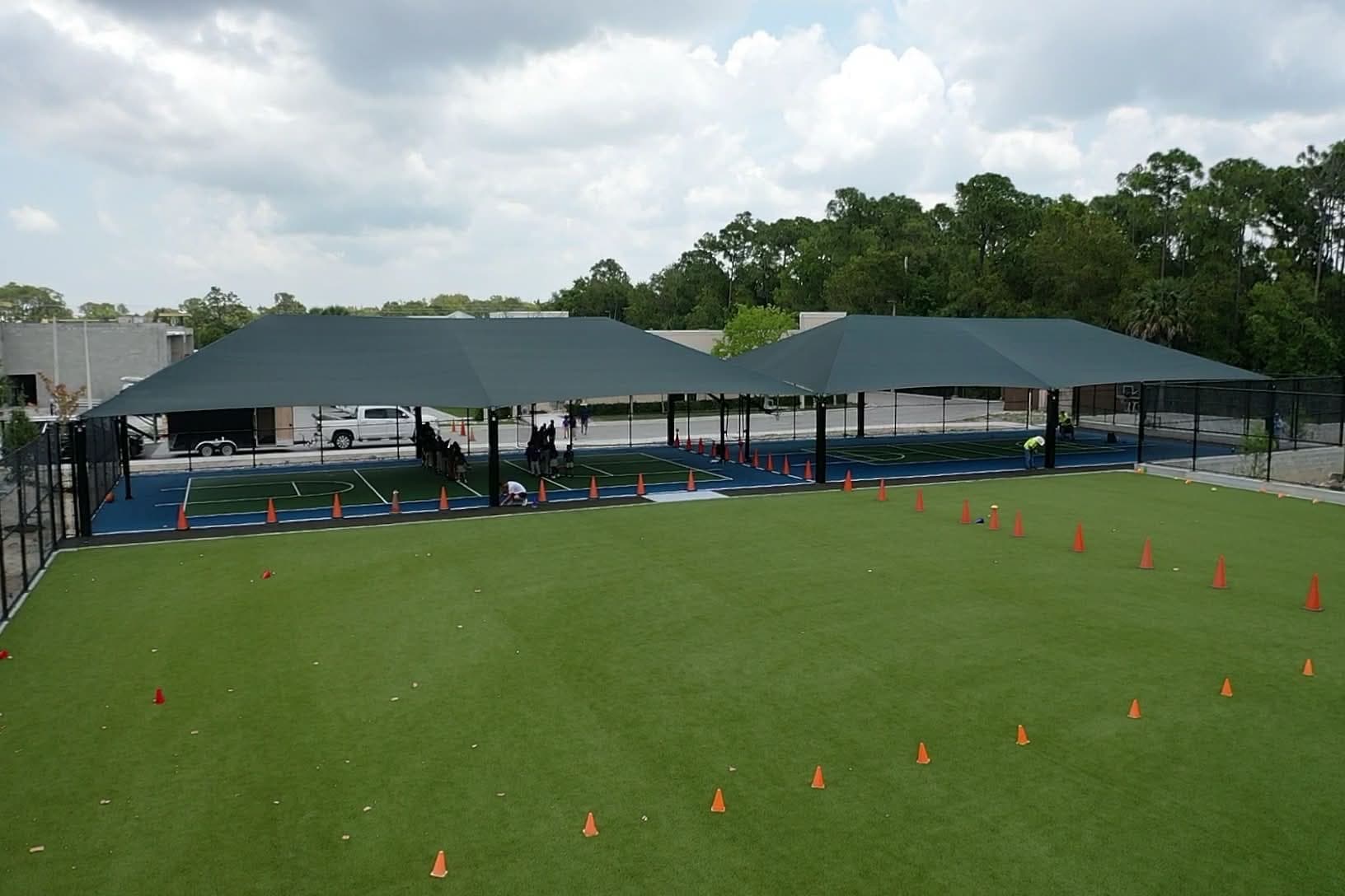 Large shade structure over sports courts